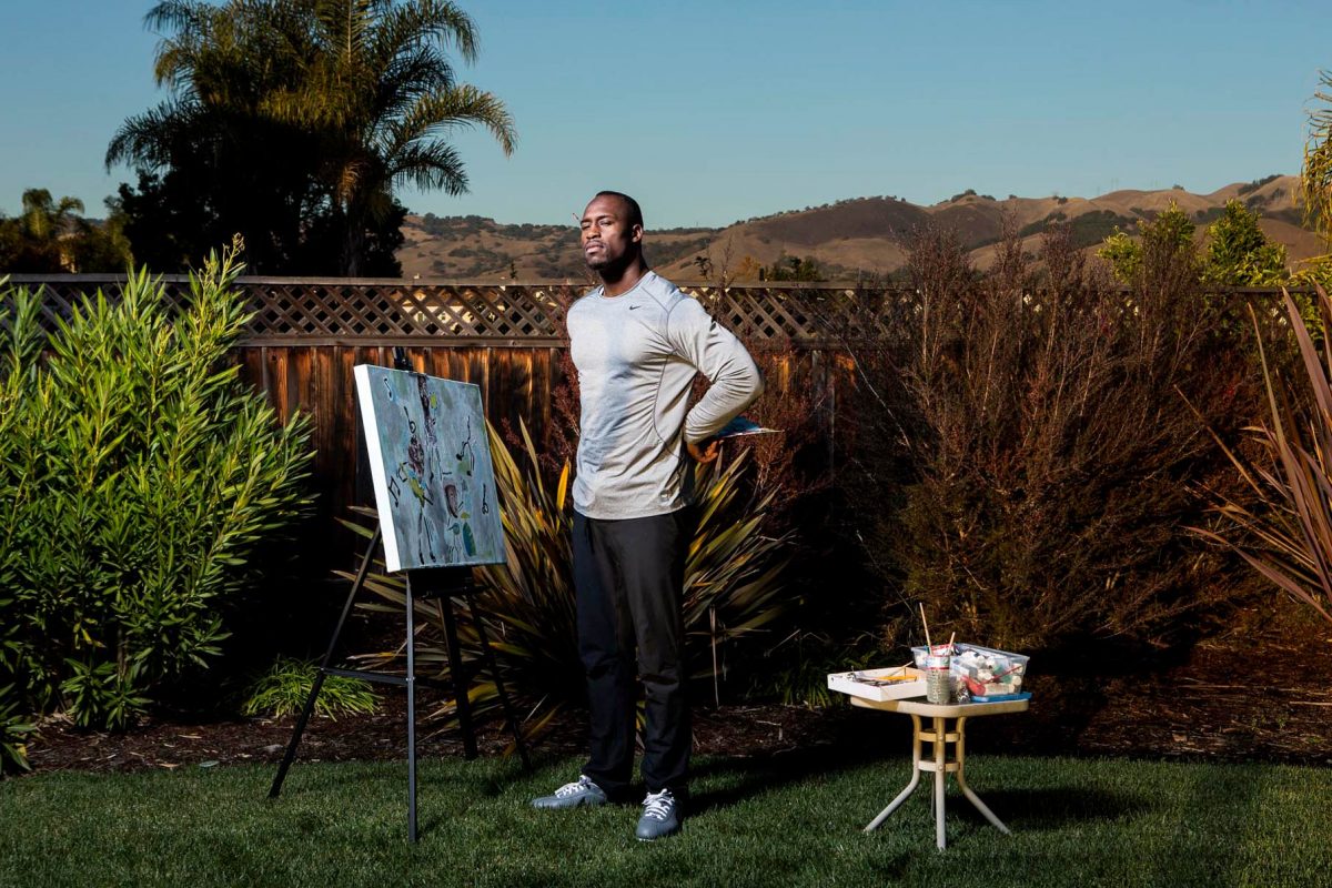 Professional football player, Vernon Davis, works on one of his paintings at home in the San Jose hills. Davis plays tight end for the San Francisco 49ers.