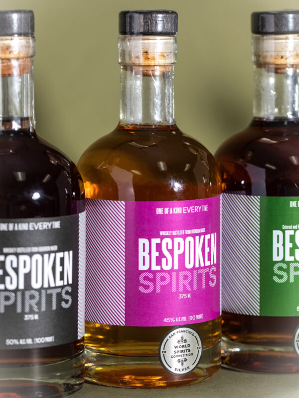 Bespoken has several products on the market, including three kinds of whiskey and a dark rum. The clear bottle, second from right, is their “source” spirit.Credit...