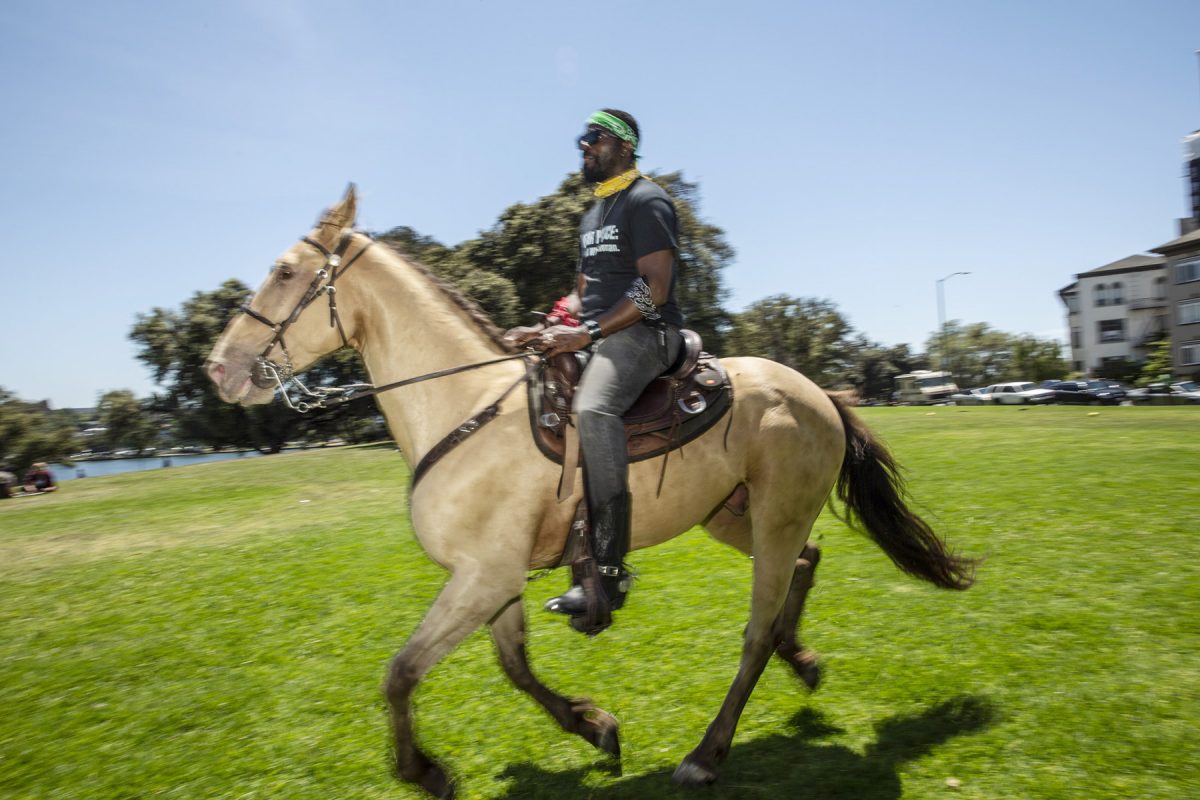 The black cowboys of Oakland ride peacefully around Lake Merritt in Oakland, California to celebrate Juneteenth.